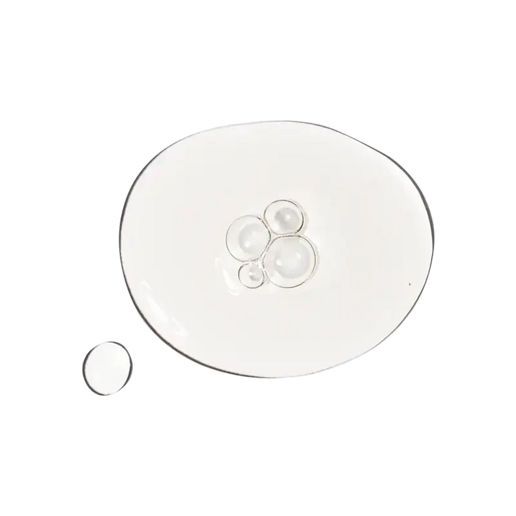Clear skincare serum texture on a transparent glass plate, hydrating facial product