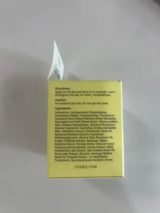 Yellow skincare product box showing directions and ingredients list for a lip treatment.