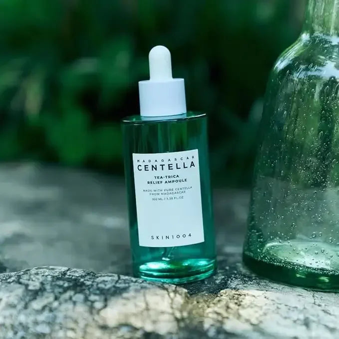 SKIN1004 Centella ampoule skincare product with dropper on natural stone outdoors