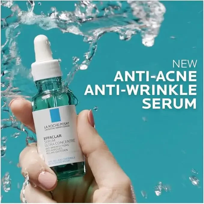 Hand holding La Roche-Posay Effaclar serum bottle with water splash, anti-acne anti-wrinkle skincare