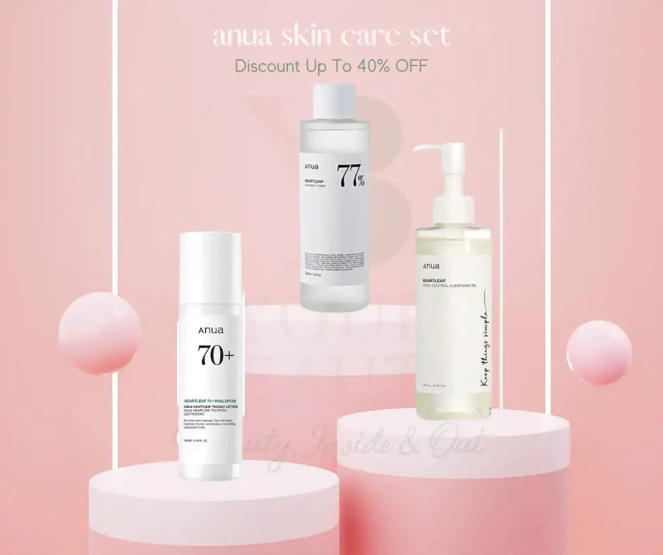Anua skin care set with toner, moisturizing lotion, and cleansing oil on pink background