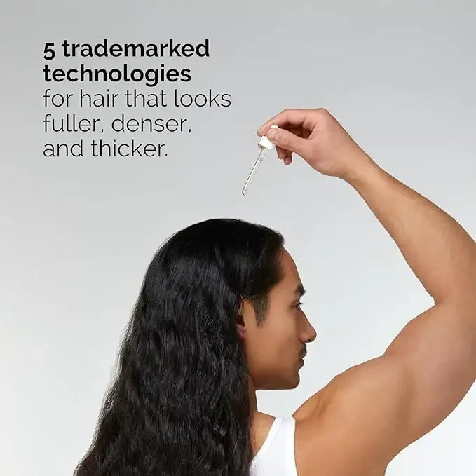 Man applying hair serum with dropper, promoting fuller, thicker hair using advanced technologies