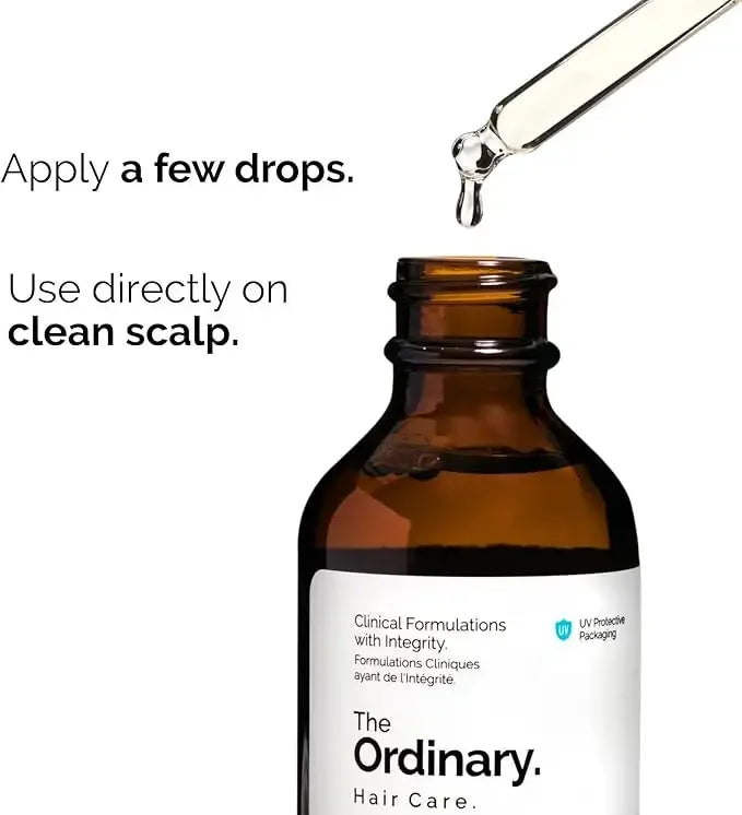 The Ordinary hair care serum dropper bottle with instructions to apply drops on clean scalp.