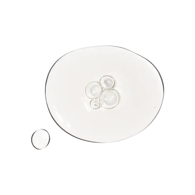 Clear skincare serum texture on a transparent glass plate, hydrating facial product