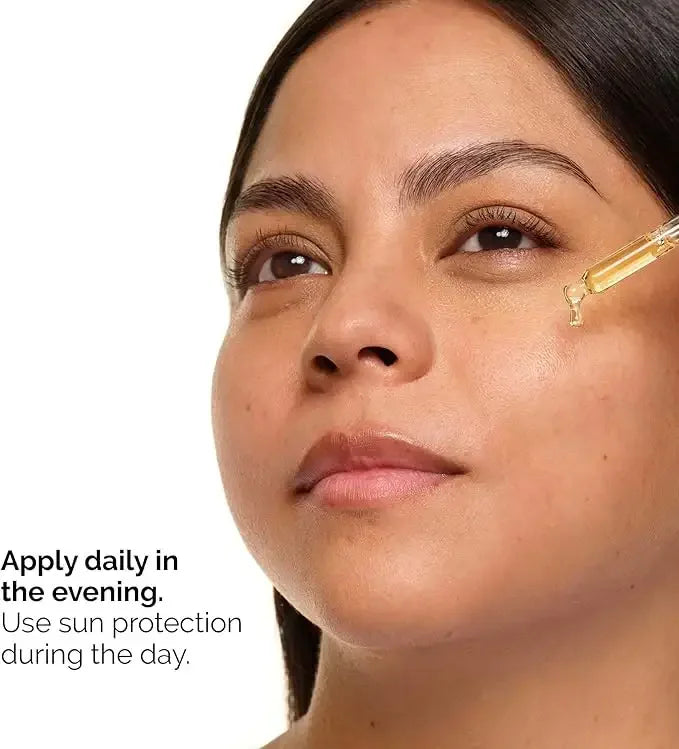 Woman applying facial serum with dropper to cheek, skincare routine, sun protection advice