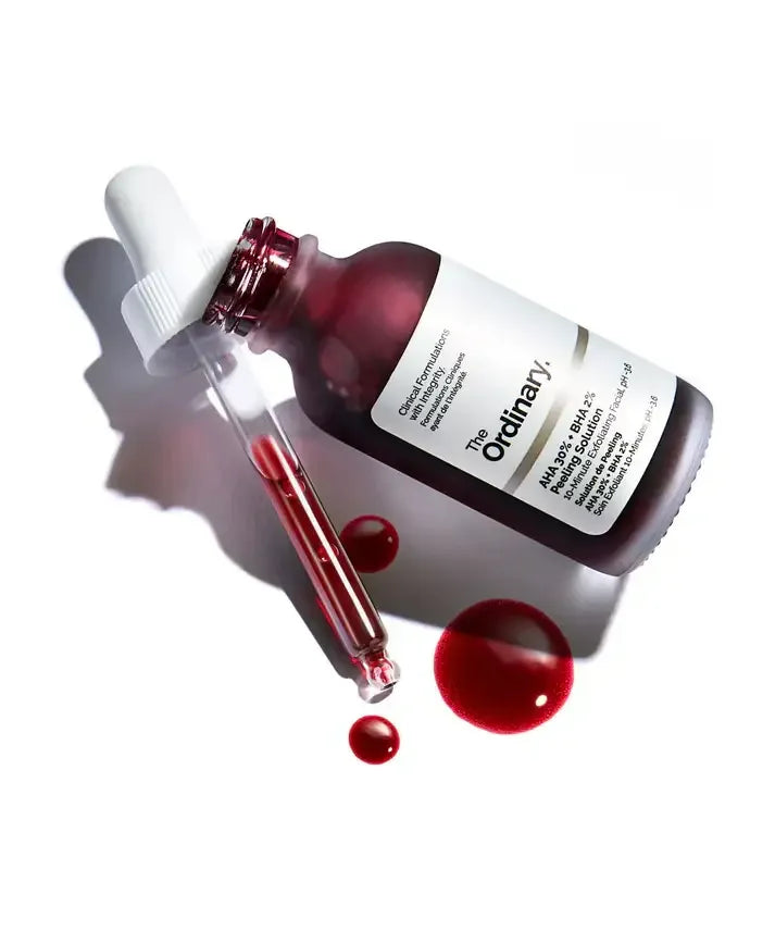 A bottle of The Ordinary AHA 30% + BHA 2% Peeling Solution with dropper and red serum