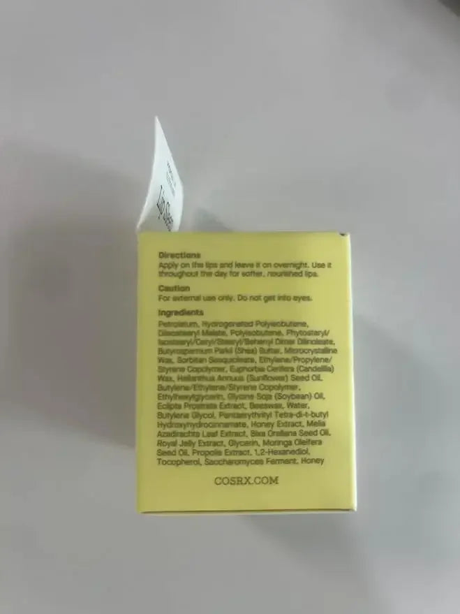 Yellow skincare product box showing directions and ingredients list for a lip treatment.