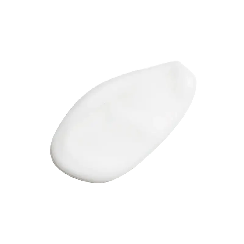 Close-up of a white creamy skincare product texture on a plain background