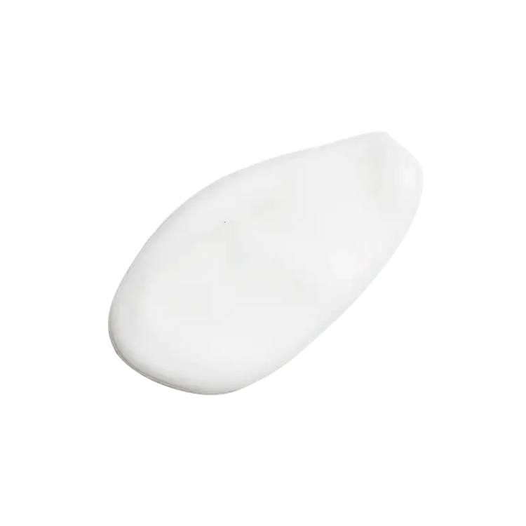 Close-up of a white creamy skincare product texture on a plain background