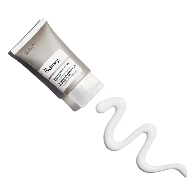 The Ordinary Vitamin C Suspension cream tube with white skincare cream on white background