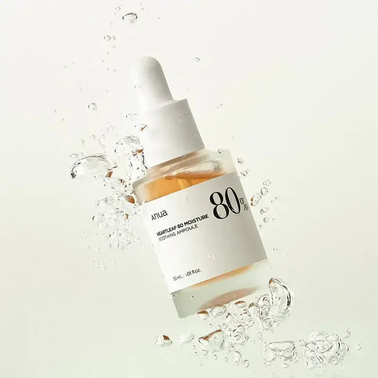 Anua Heartleaf 80 Moisture Soothing Ampoule serum bottle with water splash on white background