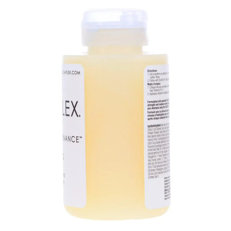 Close-up of a yellow liquid hair care product in a transparent bottle with label and instructions
