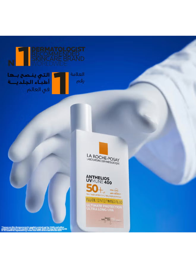 La Roche-Posay Anthelios UVMune 400 SPF 50+ sunscreen held by a gloved hand against blue background