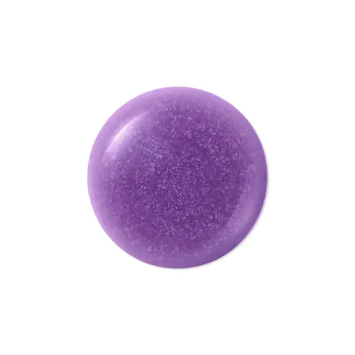 Round purple solid shampoo bar for hair care on a white background